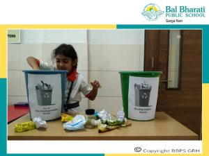 Enhancing ecological understanding: Students actively participating in waste sorting activity.