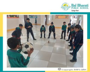 students playing with football